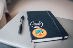 Notebook and pen how to design a logo.